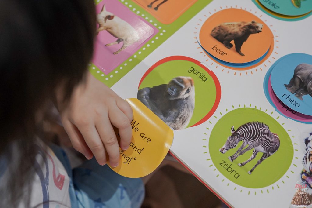Image of little girl playing with a book.